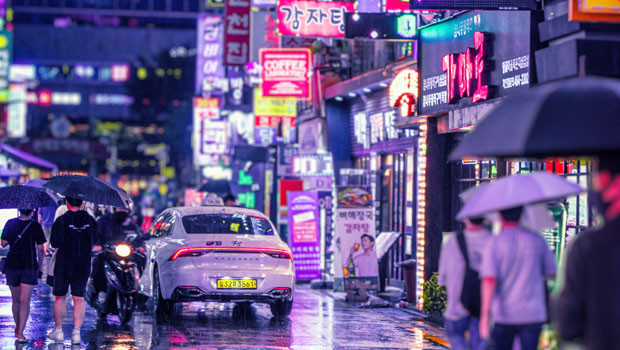 dl south korea seoul street night rain pedestrians signs neon korean won unsplash