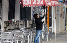 ep archivo   una camarera levanta el toldo de un bar en madrid espana
