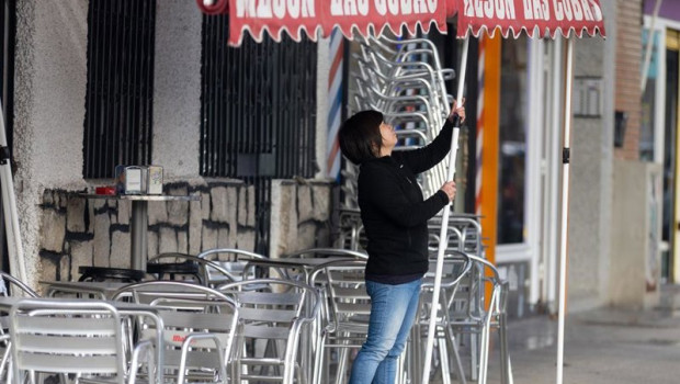 ep archivo   una camarera levanta el toldo de un bar en madrid espana