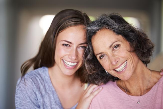 A laughing mother and daughter standing in their home and looking at the camera | MADRE E HIJA/SELMARK ep a laughing mother and daughter standing in their home and looking at the camera