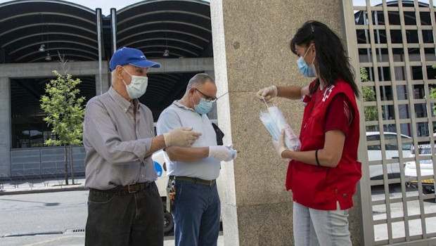 ep una voluntaria de cruz roja durante un reparto de mascarillas