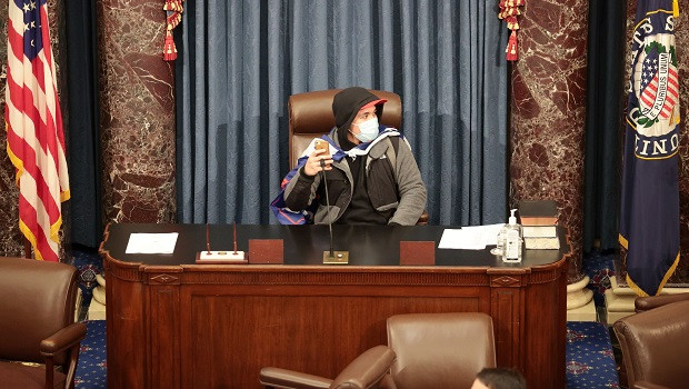 A Trump supporter in the Speakers chair after a mob stormed the Capitol capitol building stormed 2021