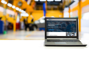 laptop white desk with blurred car garage with maintenance fixing copia 1 1 1 