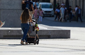 ep archivo   una mujer con un carrito de bebe paseando por madrid
