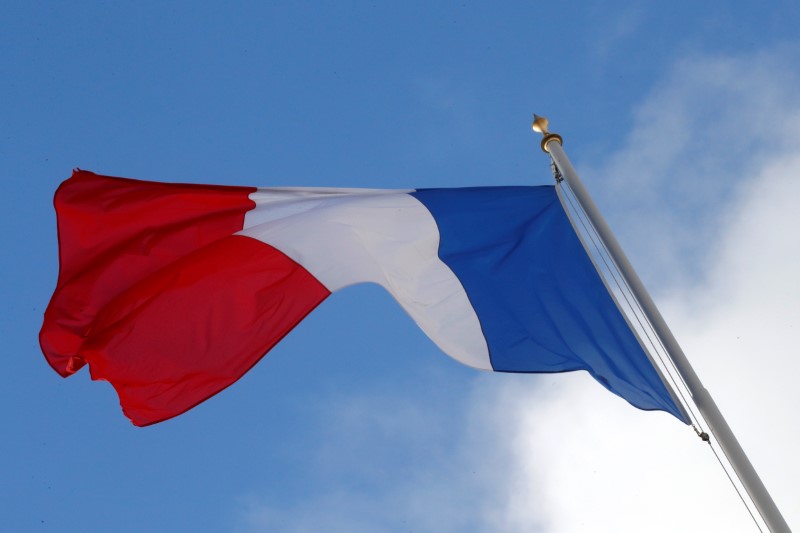 a french flag flutters in the sky over the elysee palace in paris a french flag flutters in the sky over the elysee palace in paris