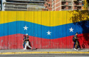ep archivo   dos personas caminan delante de una bandera venezolana a 9 de enero de 2025 en caracas