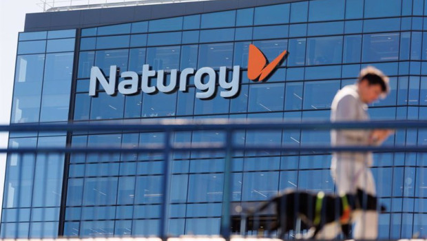 ep archivo   una persona camina frente a la sede de naturgy en madrid espana