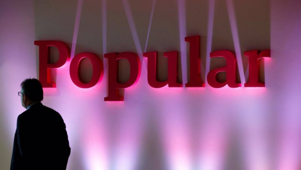 ep archivo   file photo a man stands next to the logo of spains banco popular during the banks