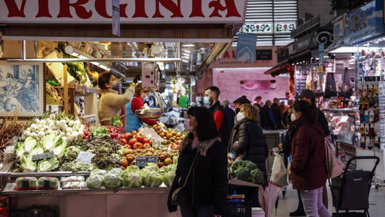 ep varias personas compran en un puesto de fruta y verdura en el mercado central de valencia